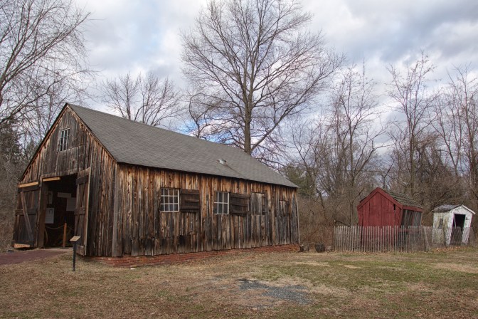 Exterior of Farley Blacksmitih Shop, with two smaller wooden sheds in background.