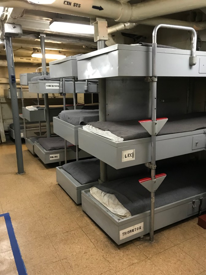 Enlisted personnel quarters with rows of bunk beds.