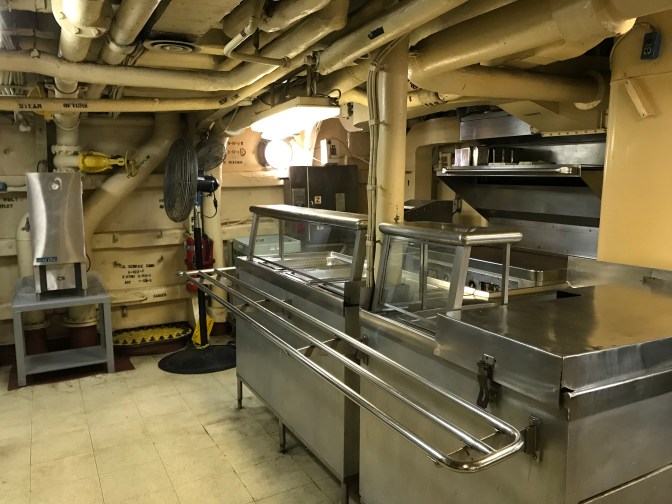 View of cafeteria buffet line and griddle in crew’s mess.