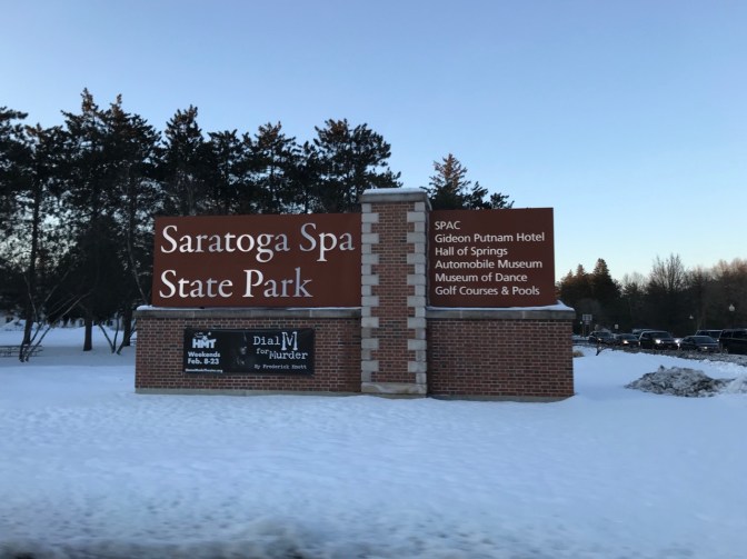 Sign that says SARATOGA SPA STATE PARK - SPAC GIDEON PUTNAM HOTEL HALL OF SPRINGS AUTOMOBILE MUSEUM MUSEUM OF DANCE GOLF COURSES & POOLS