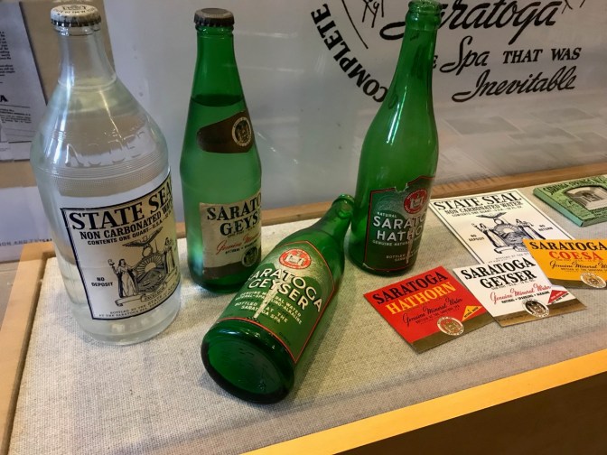 Series of bottles and ads for Saratoga Bottling Plant.