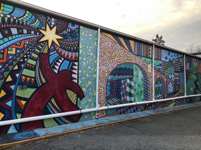 Mural with multiple shapes and patterns depicting New Brunswick and Highland Park."