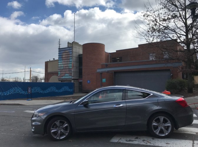 2012 Honda Accord coupe in front of back of aquarium.