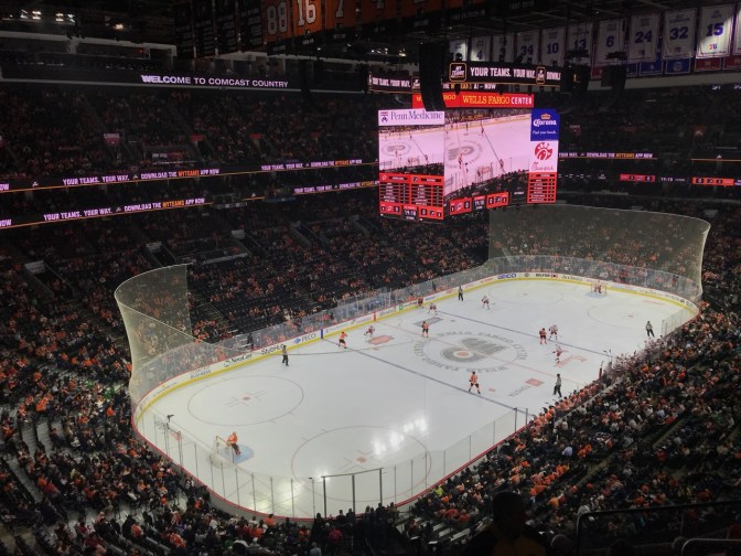 View of Wells Fargo Center in Philadelphia with Flyers and Carolina Hurricanes playing hockey.
