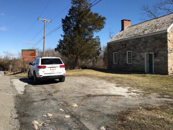 White 2014 Jeep Grand Cherokee parked in front of Nelden-Roberts Stonehouse.