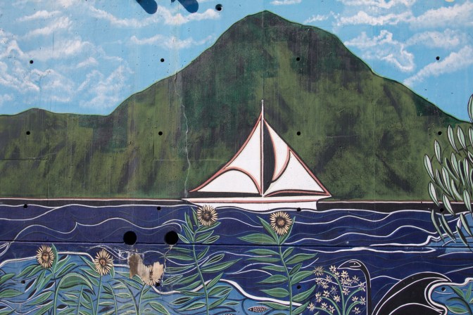 Sailboat sailing along river.