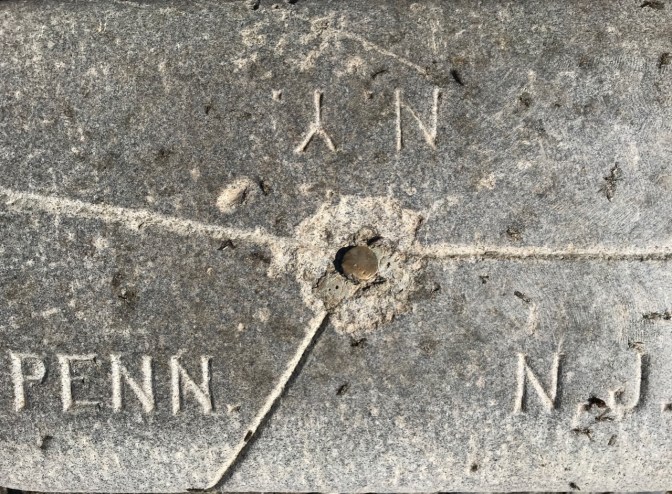 Top of monument, divided into three sections, inscribed with NY, NJ and PENN.