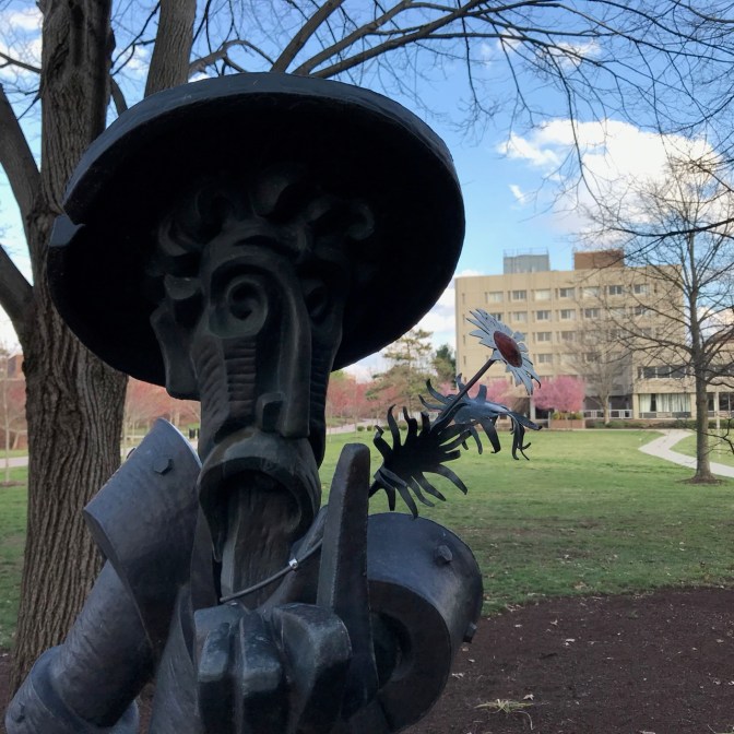 Sculpture of Don Quixote holding a flower.