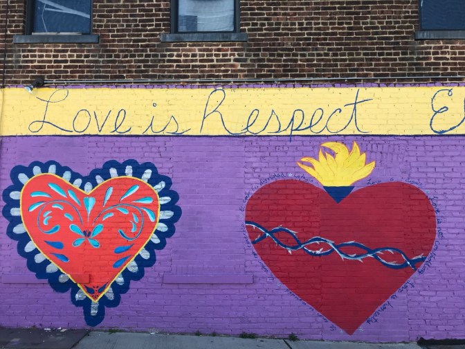 Two mural hearts, with the words "Love is Respect" written above.