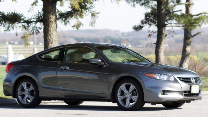 2012 Honda Accord park in front of trees, with rolling hills in background.