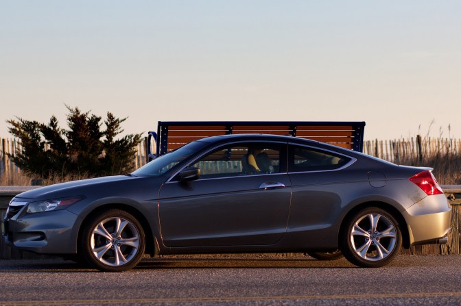 2012 Honda Accord parked along sidewalk near beach.