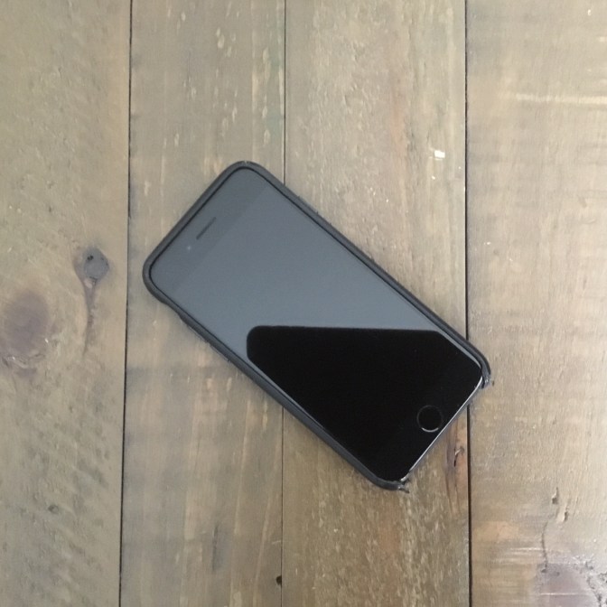 Apple iPhone 7 on wooden table.