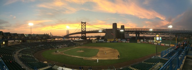 Panoramic view of baseball field at sunset.