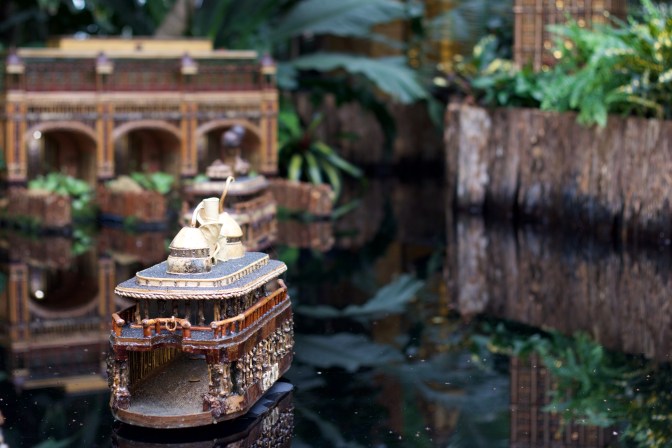 View of ferry made of plants, approaching model of ferry terminal.