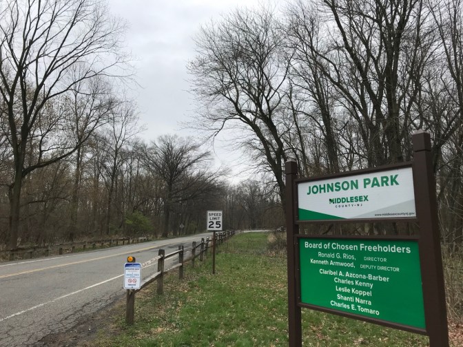 Entrance to Johnson Park. A green and white sign says JOHNSON PARK MIDDLESEX COUNTY NJ