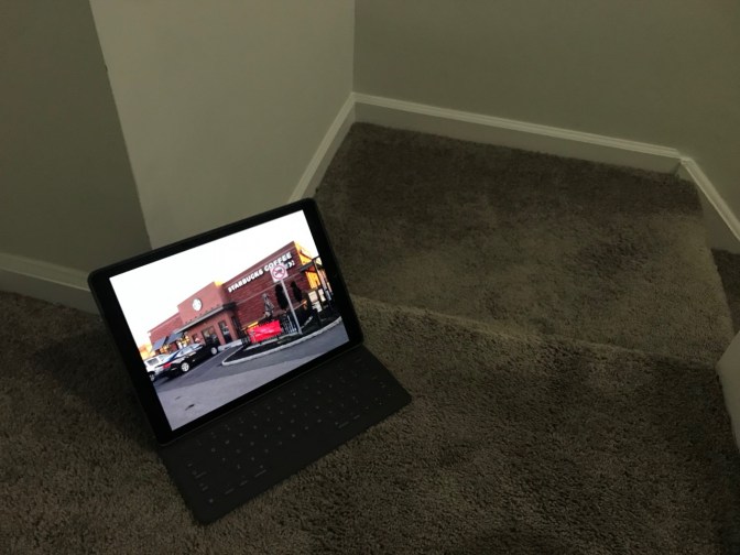 iPad on staircase, displaying a Starbucks coffee shop.