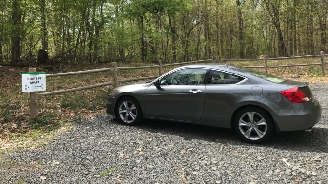 2012 Honda Accord coupe parked in empty gravel lot. A sign near the coupe says STAY 6FT APART.
