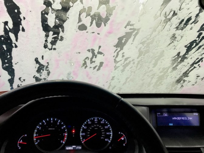View of car dashboard as it goes through car wash.