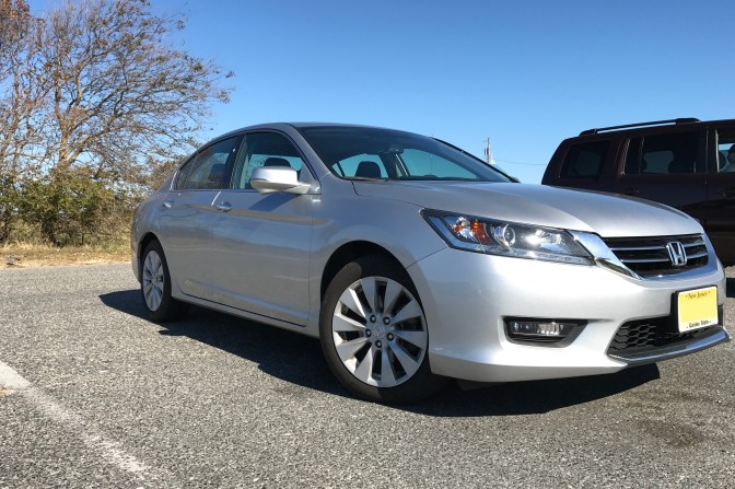 2015 Honda Accord sedan in silver, parked in parking lot.