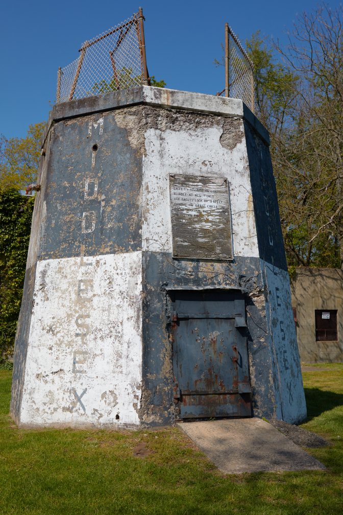 Crumbling white and black observation tower.