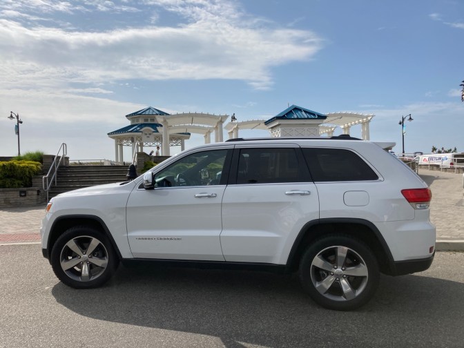 White Jeep Grand Cherokee in front of waterfront pavilions in Sea Isle City.