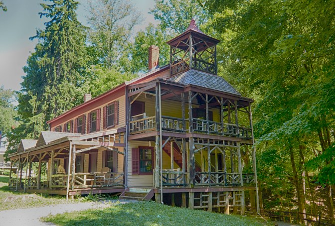 View of schoolhouse and general store building on park.
