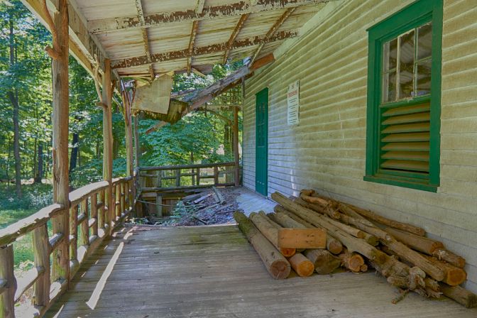 Porch of house that is in process of collapsing.