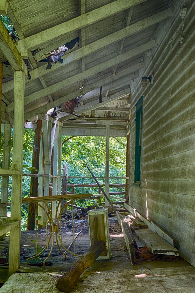 Decaying porch, with debris on it.