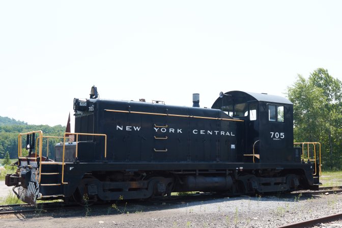 Black railroad engine with 705 written on side.