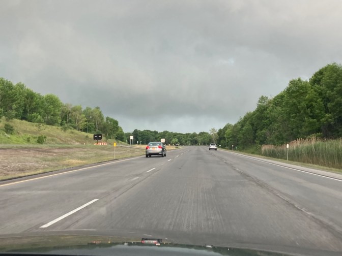 View of thunderstorms above road on New York Thruway.