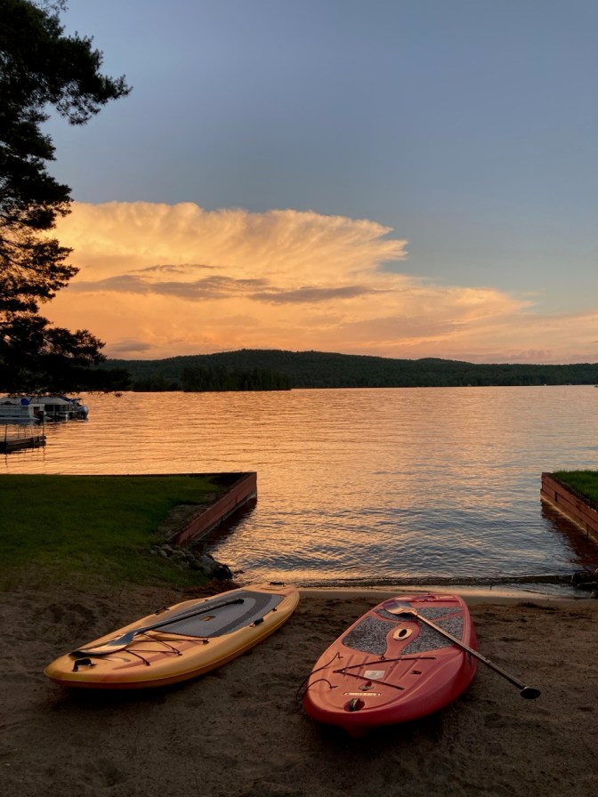 Two paddle boards beside dock on Fourth Lake.