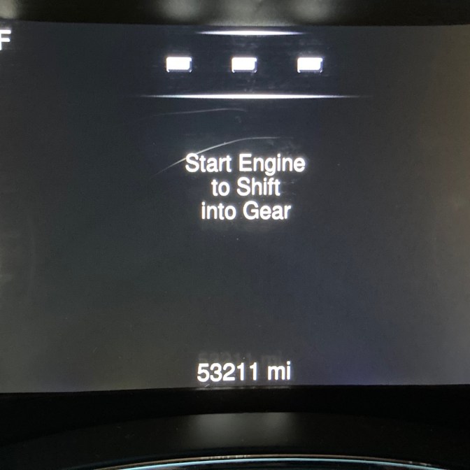 Car odometer reading 53211 miles.