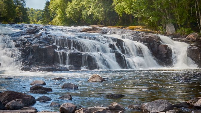 View of Buttermilk Falls, with slow shutter speed to create milky waterfall.