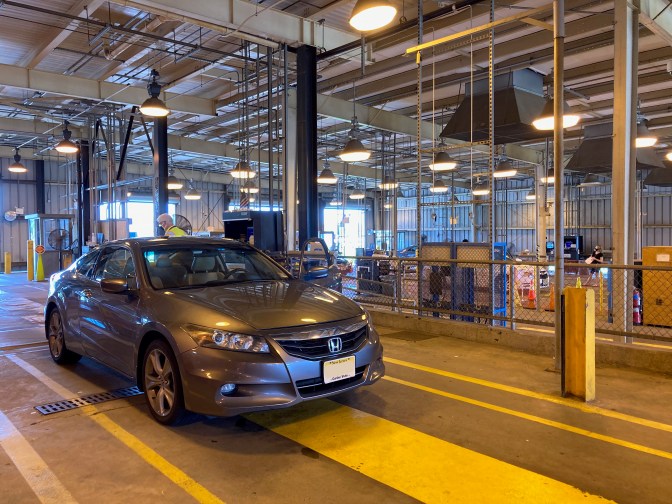 Gray Honda Accord inside of NJ state inspection station.