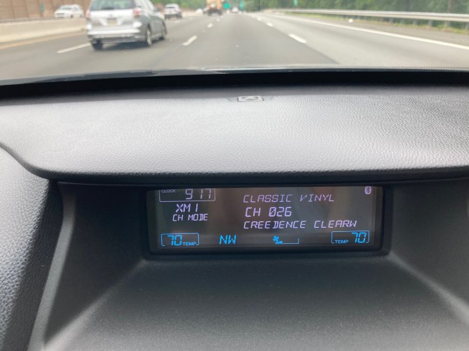 Car stereo display in dashboard reading CLASSIC VINYL CH 026 CREEDENCE CLEARW