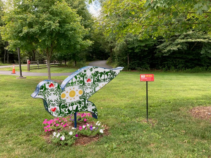 Bird sculpture, painted in psychedelic color scheme.