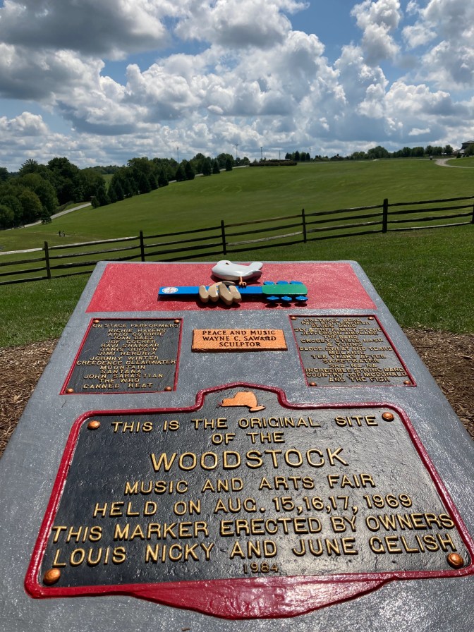 Stone marker that says THIS IS THE ORIGINAL SITE OF THE WOODSTOCK MUSIC AND ARTS FAIR HELD ON AUG 15,16,17 1969