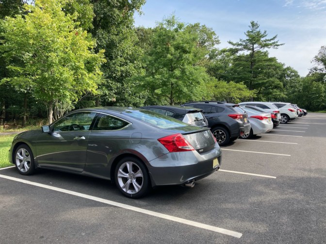 2012 Honda Accord coupe parked in row of cars in parking lot.