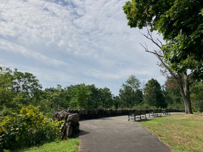 Scenic overlook with rock wall in foreground.