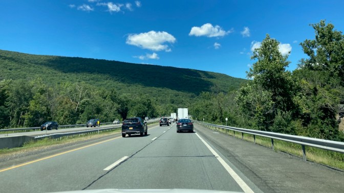 View of I-87 NY Thruway with hills in distance.