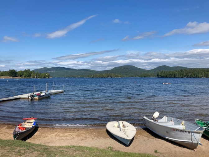 Blue Mountain Lake, with boats in foreground.