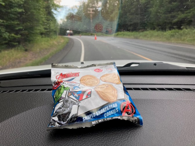 Bag of animal crackers on dashboard of Jeep.