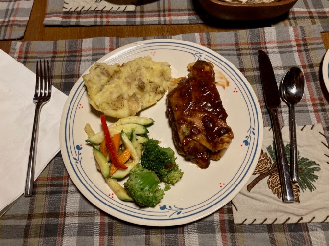 White plate with meatloaf, mashed potatoes, and mixed vegetables.