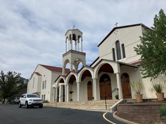 White Jeep Grand Cherokee parked outside St. George's Greek Orthodox Church.