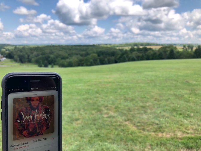 iPhone with Jimi Hendrix album on screen.