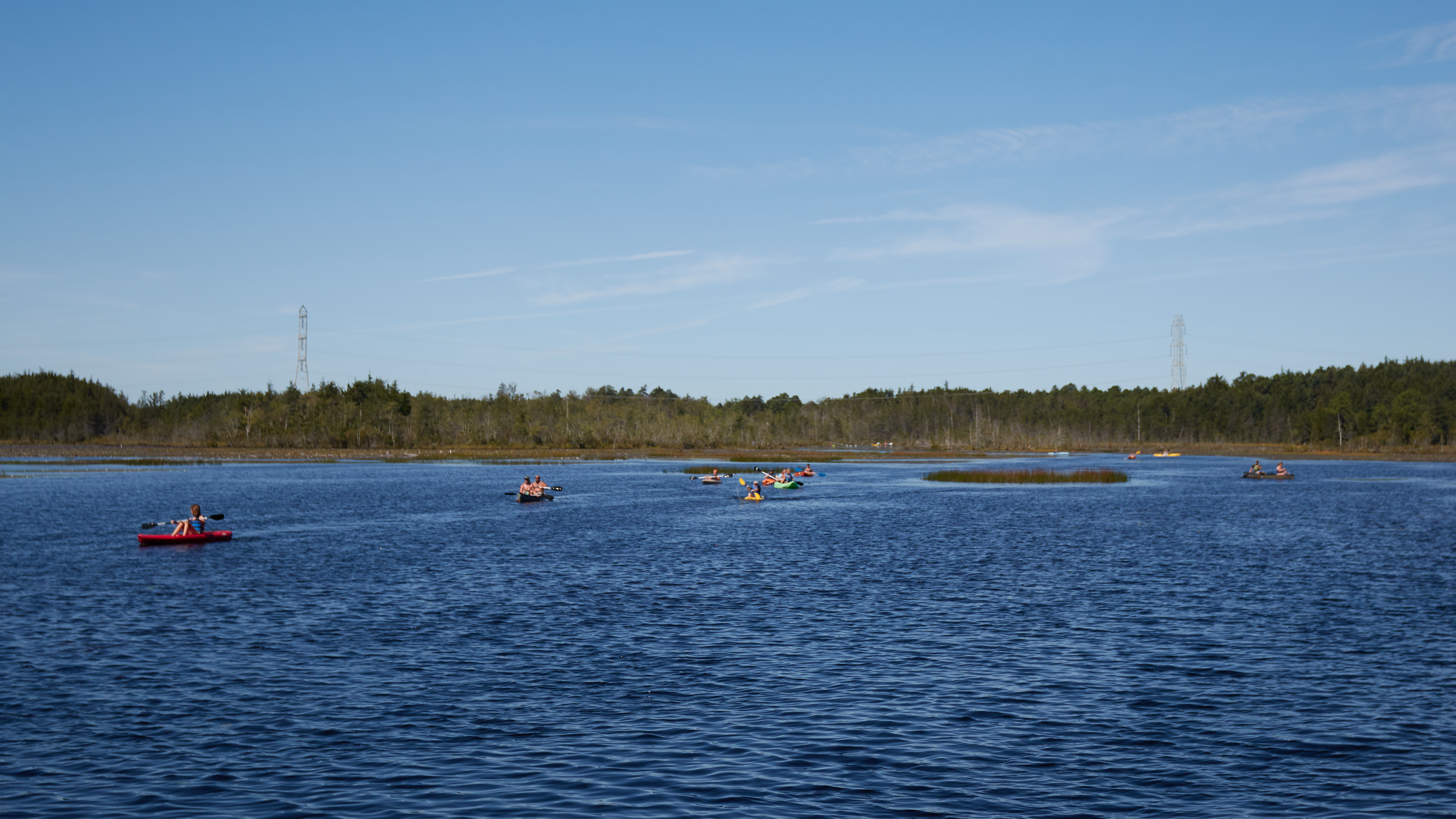 Mill Pond reservoir, with kayakers on the water.