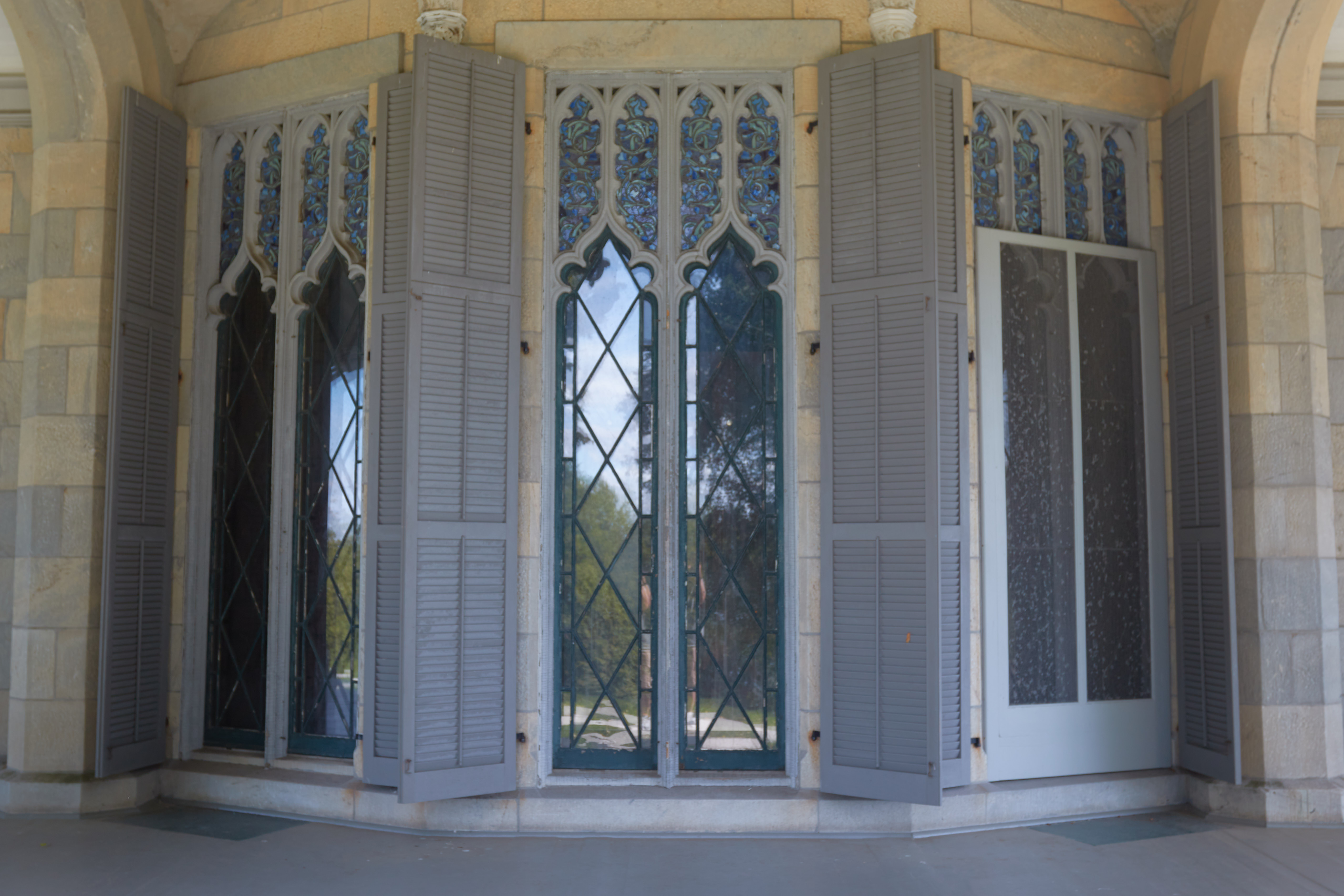 Floor-to-ceiling windows of house, from exterior.