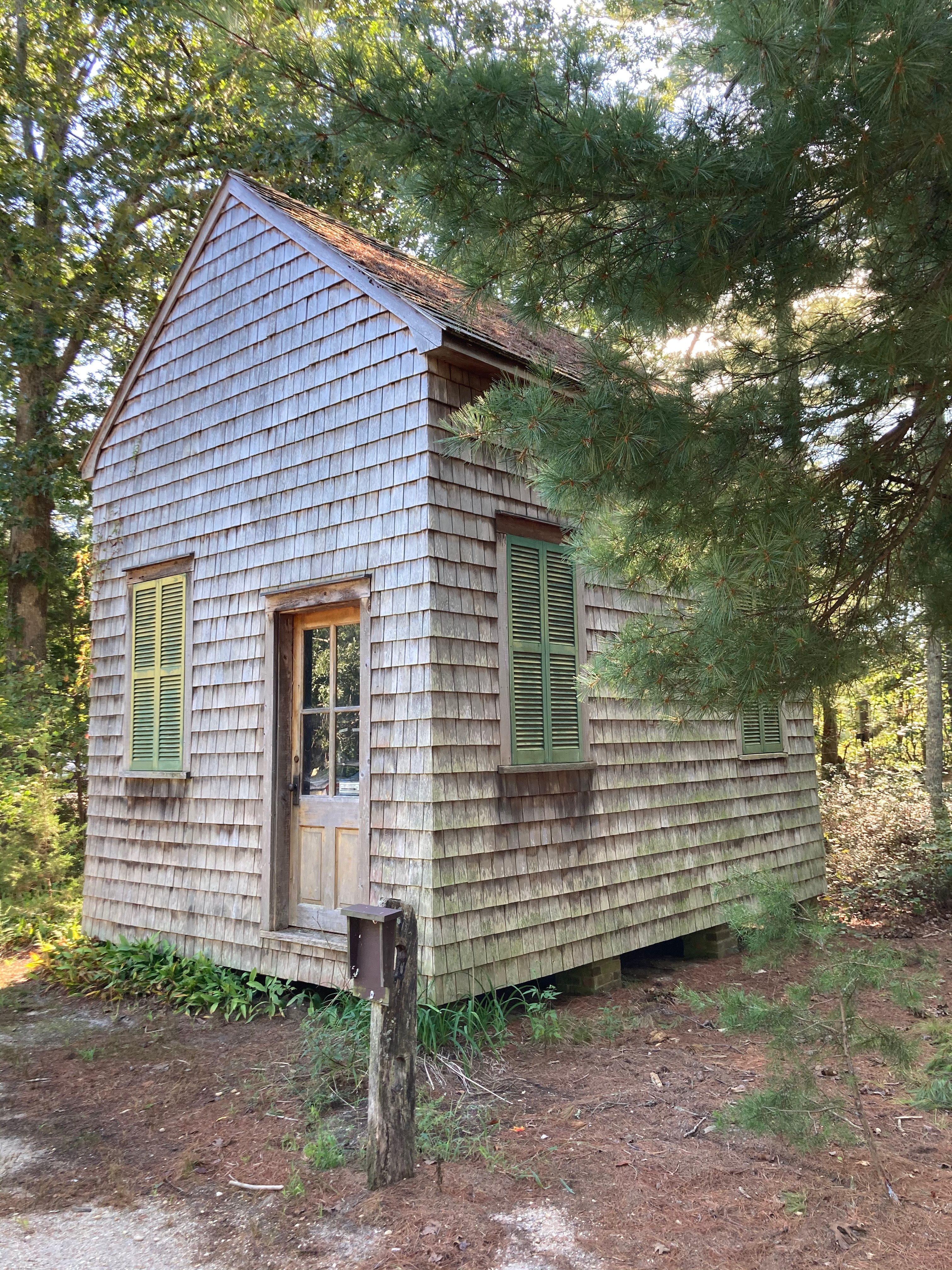 One-room school house covered in cedar shake siding.
