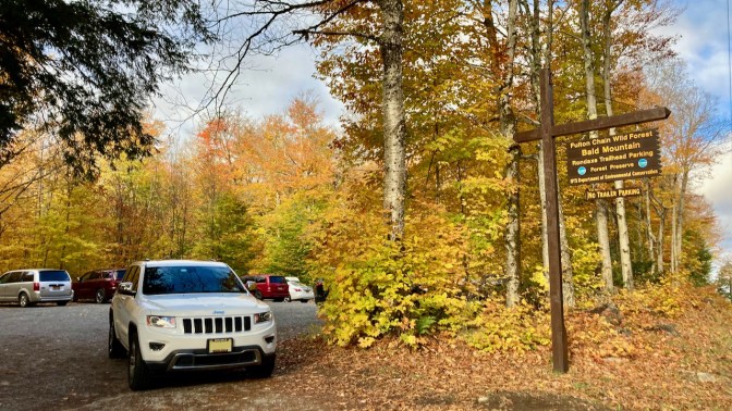 White Jeep Grand Cherokee parked in front of Bald Mountain parking lot.