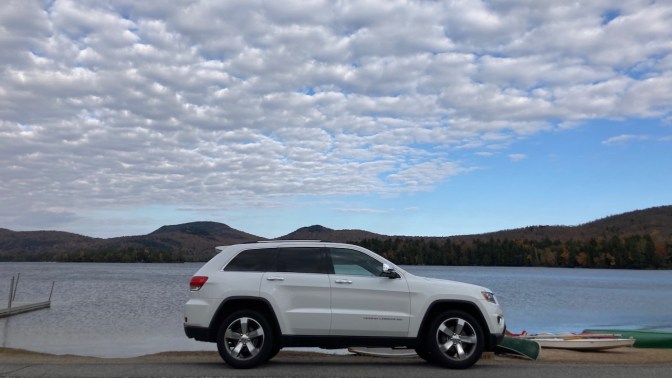 2014 Jeep Grand Cherokee parked in front of Blue Mountain Lake.